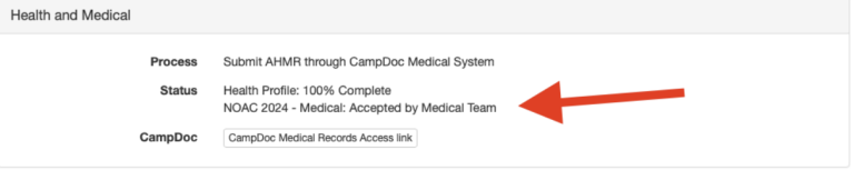 A screenshot of a health and medical status update. The process mentions submitting an AHWR through CampDoc Medical System. The status shows the health profile is 100% complete and accepted by the medical team for NOAC 2024. A red arrow points to the text.