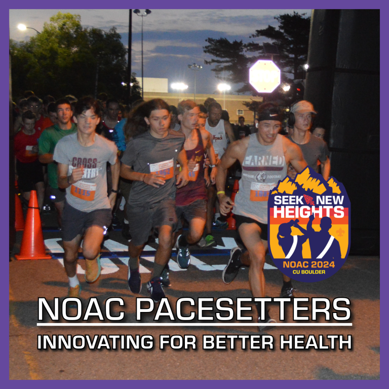 A group of runners participating in a nighttime race are nearing the starting line. The banner reads, "NOAC Pacesetters: Innovating for Better Health." To the side, a logo says, "Seek New Heights NOAC 2024 CU Boulder.
